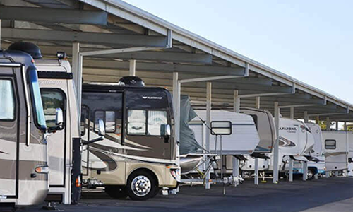 Covered RV and boat storage under steel canopy structures at a MakoRabco facility.