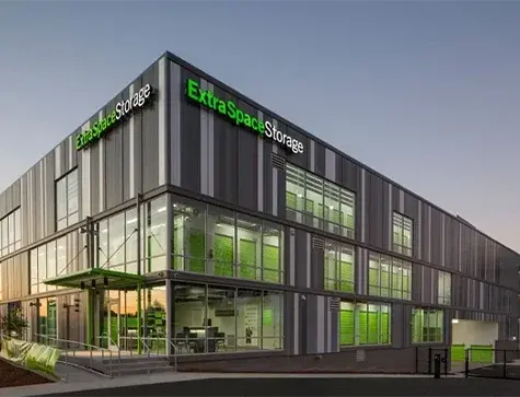 Modern multi-story self storage building with glass facade and upper-level units, illustrating a typical multi-level storage facility design.