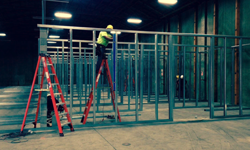 Construction crew installing steel framing during a self storage conversion project